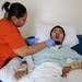 Luneshia Williams, an LPN, suctions liquid from her son Lukequan's tracheostomy tube as he gasps for air on Wednesday afternoon in Romulous. Melanie Maxwell I AnnArbor.com